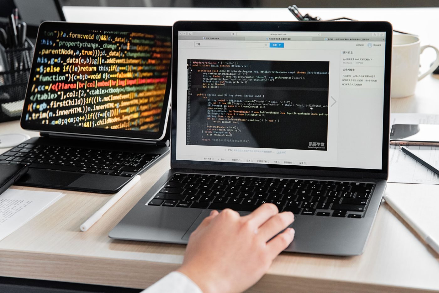 Developer writing code on a laptop