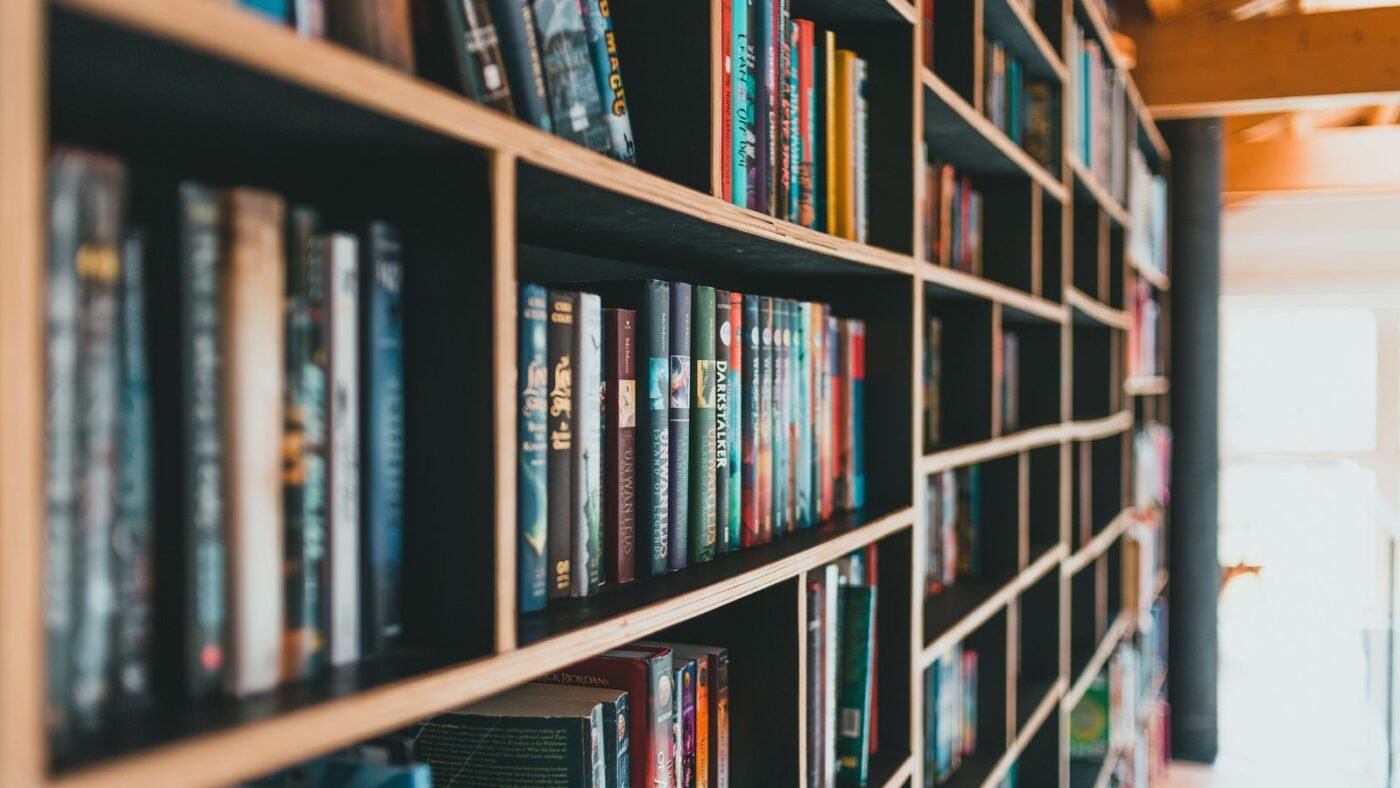 Colorful books arranged on modern shelves in a bright library