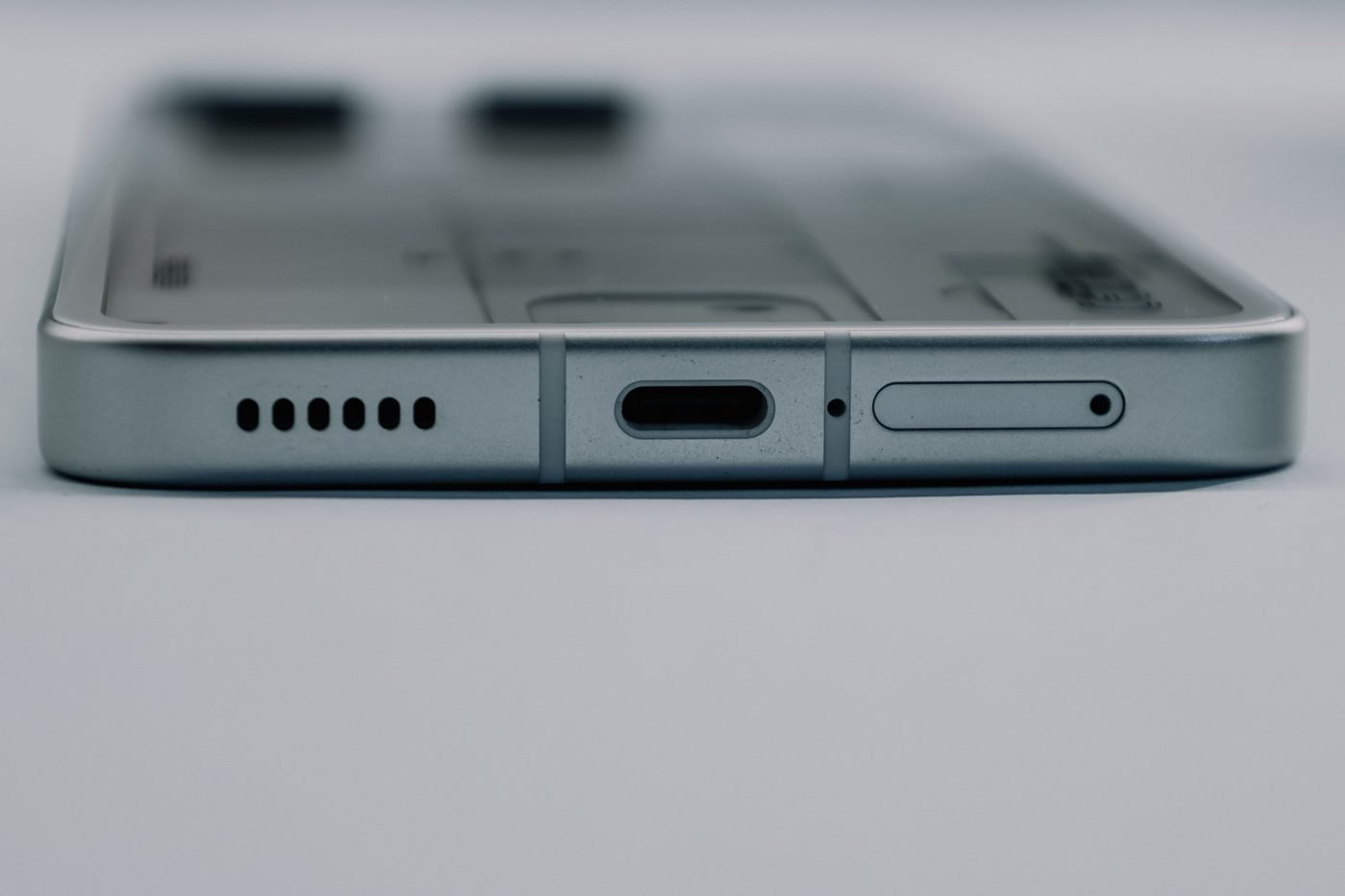 Close-up of a smartphone USB-C charging port and speaker grille