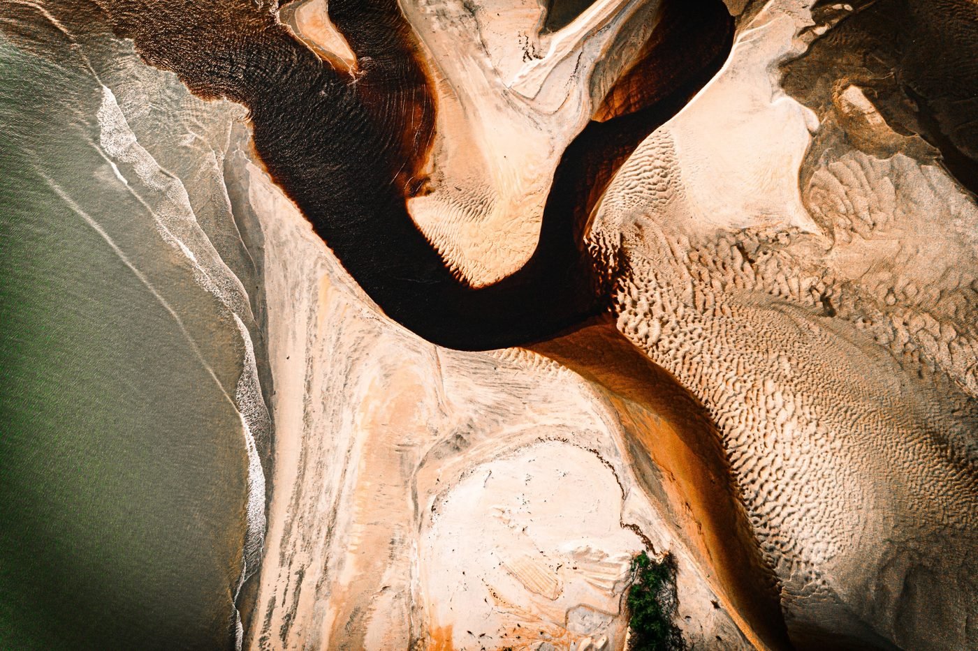 Aerial view of a river delta branching toward the sea