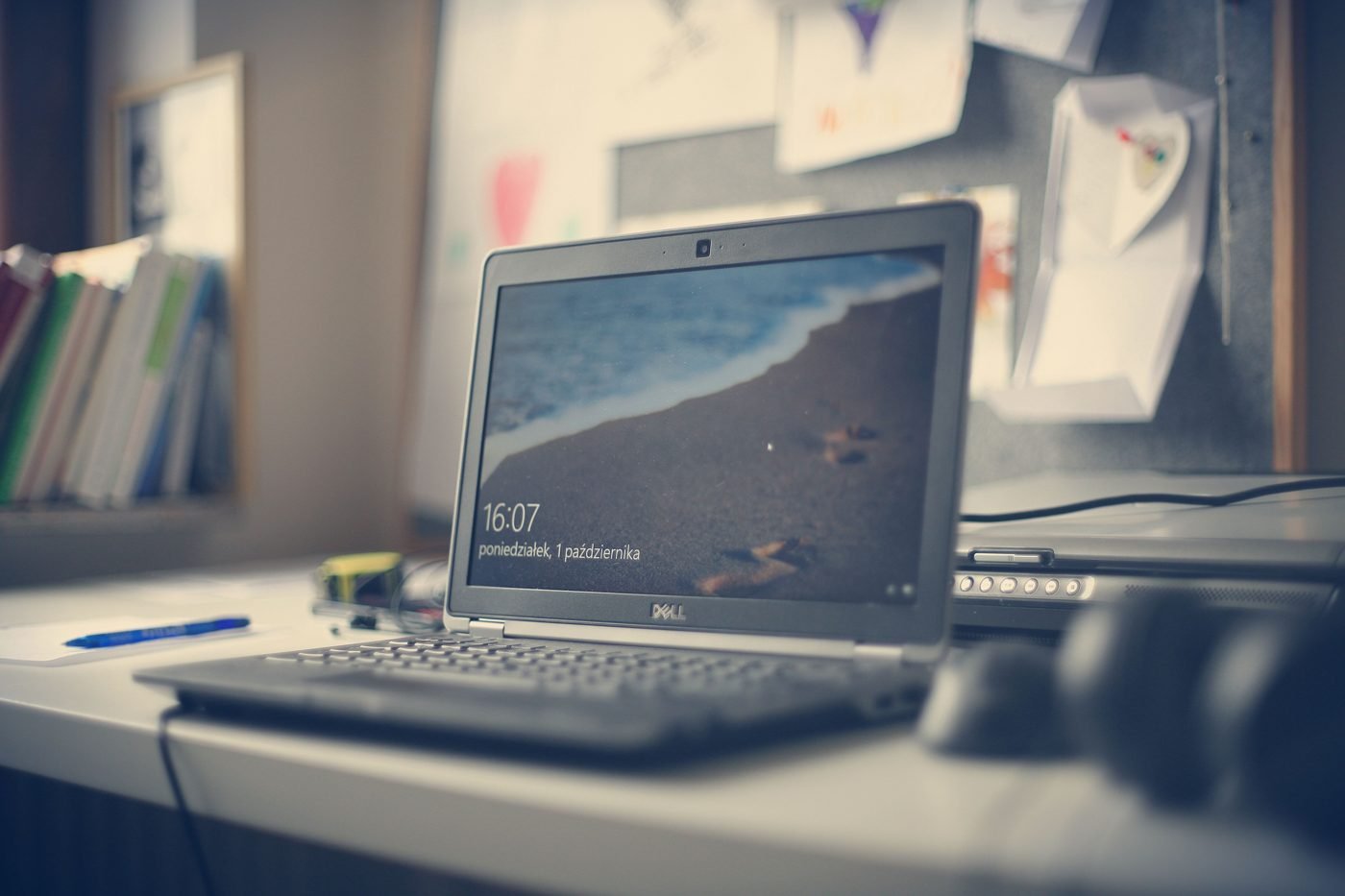 Laptop on a desk by a window in a home office