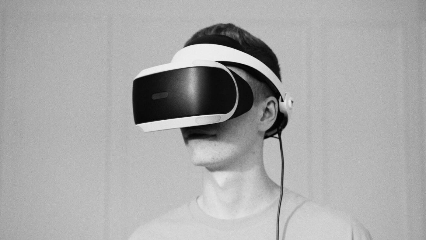Black and white photo of a man wearing a head-mounted display